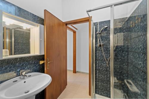 uma casa de banho com um lavatório e um chuveiro em La casa Rosa em SantʼAnna Arresi
