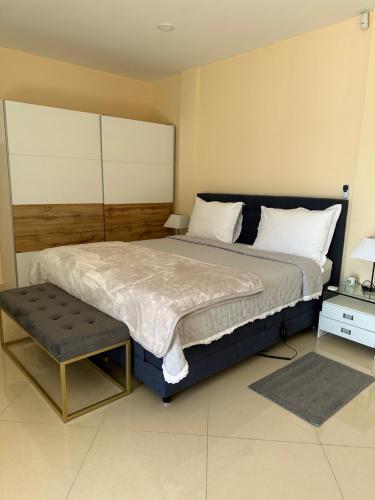 a bedroom with a large bed and a stool at Apartments Villa Isabella in Opatija
