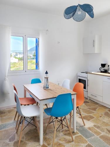 a dining room with a table and chairs at SempreViva Sea Houses in Dhiakofti