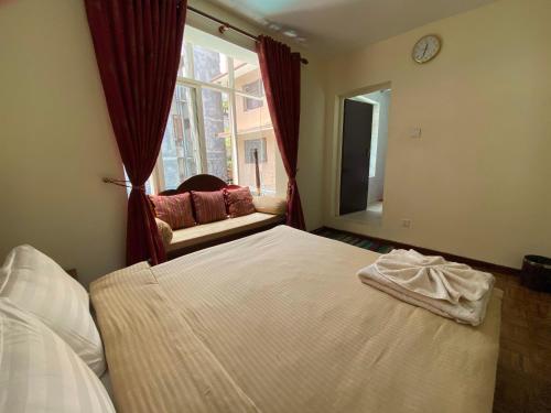 a bedroom with a large bed and a window at Alobar1000 Hostel in Kathmandu