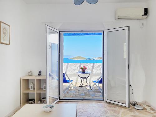 a room with a sliding glass door with a view of the ocean at SempreViva Sea Houses in Dhiakofti