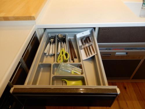 an open drawer in a kitchen with some utensils at マムヴィッラIn平安座島の一軒家 in Henza