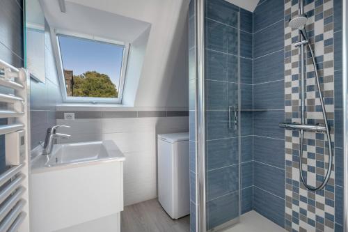 a bathroom with a sink and a shower at Appartement vue mer et les pieds dans l'eau! in Saint-Sébastien