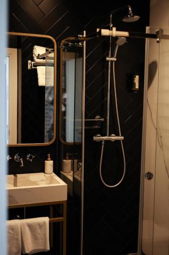 a bathroom with a shower and a sink at Gruner Hotel in Lviv