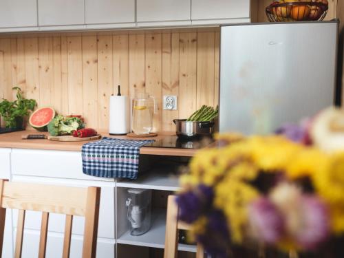 a kitchen with a counter top with a sink and a counter top at Miło las widzieć in Ciwoniuki