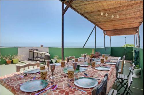 a table with plates and glasses on a patio at Hacienda La Extremeña in Güimar