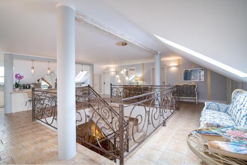 a living room and dining room with a spiral staircase at Villa Mare in Łeba