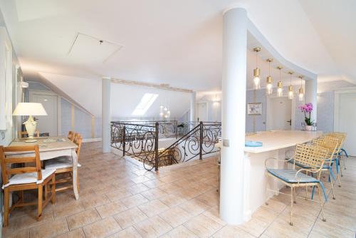 a dining room and living room with a table and chairs at Villa Mare in Łeba