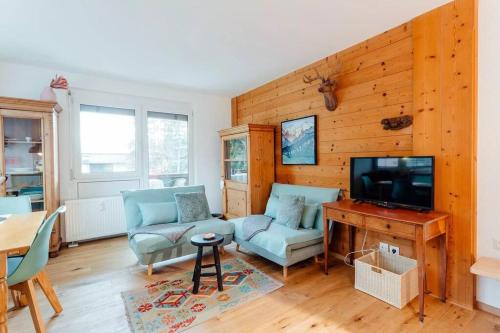 uma sala de estar com um sofá e uma televisão em Chalet-Apartment Seefeld and Chill HARMONY im Zentrum mit Netflix for free em Seefeld no Tirol