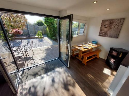 a view of a dining room with a sliding glass door at Perfect Cowes retreat with Hot Tub in Cowes