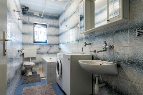 a bathroom with a toilet and a sink at Villa Daja - Adriatic Luxury Villas in Oklaj