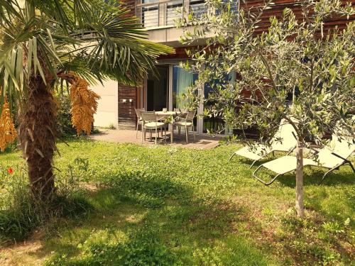 a backyard with a table and a palm tree at Apartment Matthäus in Cermes