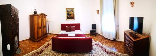 a room with a bed and a dresser in it at Weisz Castle style Apartment-City Center-Free Private Parking,Wifi,Air conditioner in Carei