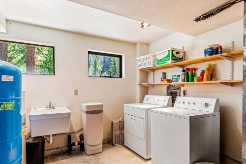 a laundry room with two washers and a sink at Selby Knoll Estate Main House and Guesthouse in Harrison