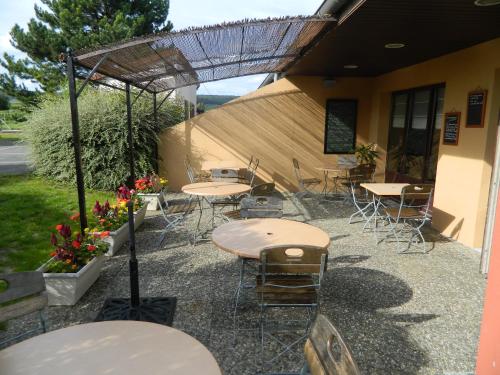 a group of tables and chairs outside of a building at Campanile Epernay - Dizy 51530 in Épernay