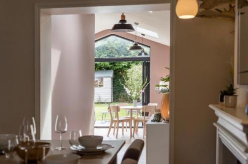 a kitchen and dining room with a table and chairs at Fallow Cottage in Lyndhurst