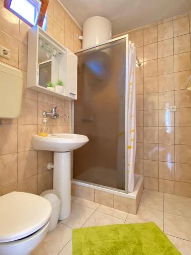 a bathroom with a shower and a sink and a toilet at Apartment Almira with sea view in Krk