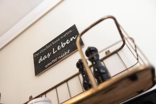 a sign on a wall next to a bunch of bottles at Ferienhaus Miarwuefki in Rantum