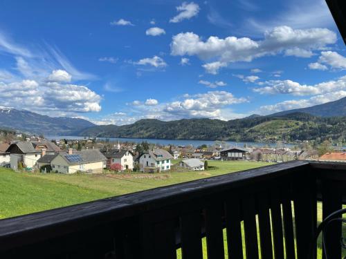 a view from a balcony of a town and a lake at Maxi'Seeblick Apartments in Seeboden