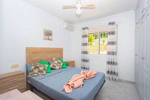 a bedroom with a blue bed and a window at CH Buganvillas Ciudad Quesada in Ciudad Quesada