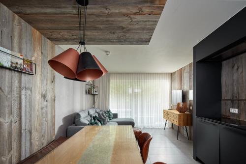 a living room with a table and a couch at Schima Drosa Apartments - Studios - by Pferd auf Wolke in Gaschurn