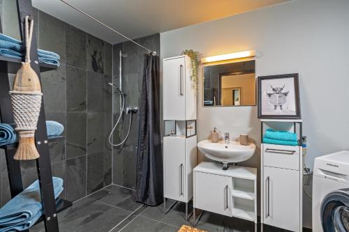 a bathroom with a sink and a shower at WohnFühlen in Dresden in Dresden
