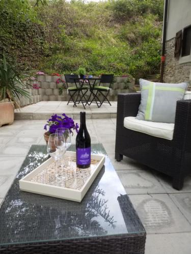 a bottle of wine sitting on a table on a patio at Casa Langhe di Mango - Moscato in Mango
