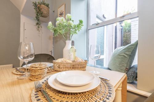 a dining room table with a plate and wine glasses at Historic Hideaway Waterford City in Waterford