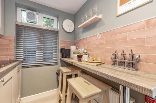 a kitchen with a counter and a clock on the wall at Historic Hideaway Waterford City in Waterford