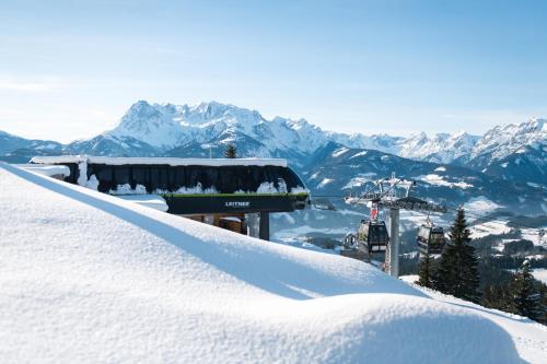 a ski lift sitting at the top of a snow covered mountain at Apart Hotel Alpenhof Werfenweng in Werfenweng