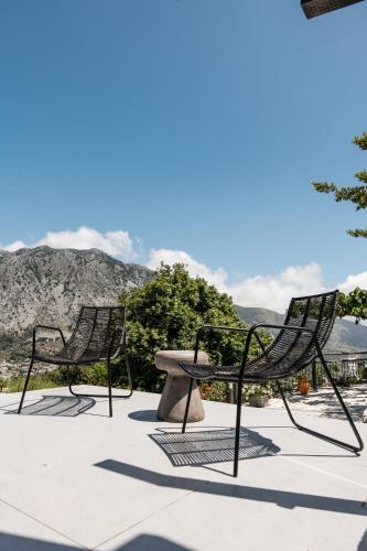 a group of chairs and a table on a patio at Eumelia Iconic Villa, with Heated Pool & Whirlpool, By ThinkVilla in Asigonía