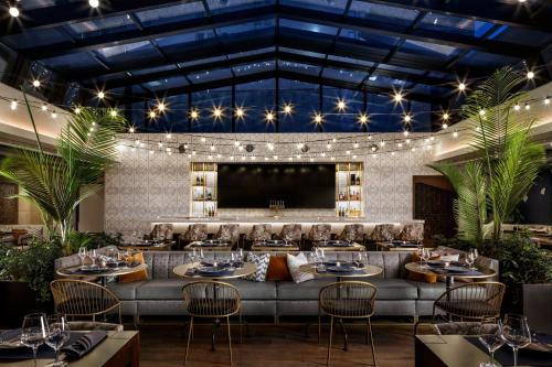 a restaurant with a large couch and a large screen at Rand Tower Hotel, Minneapolis, a Tribute Portfolio Hotel in Minneapolis