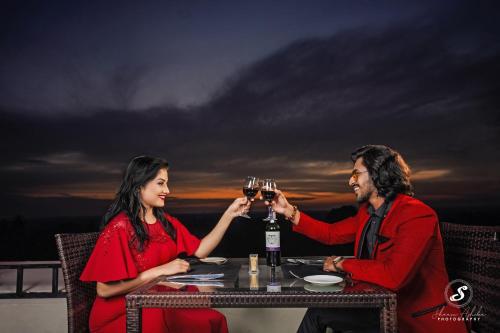 a man and woman sitting at a table drinking wine at Hotel Royal Ramesses - Katunayake in Seeduwa