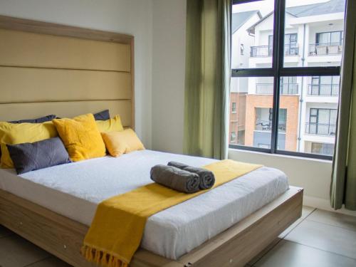 a bedroom with a large bed with a large window at 6 The Blyde Crystal Clear Lagoon 2 Bedroom Apartment in Pretoria