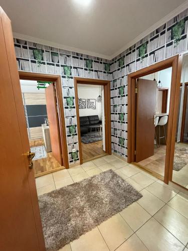 a living room with tiles on the walls at Apartment Ema in Novi Sad