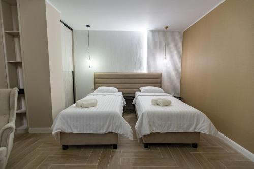 a room with three beds with towels on them at DelSool MAMAiA in Mamaia