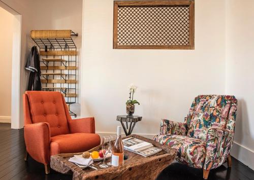 a living room with a chair and a coffee table at Circa 1928 in Albury