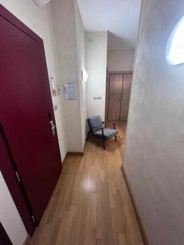 a hallway with a door and a chair in a room at Residence Star in Turin