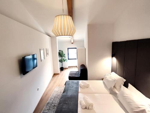 a hotel room with a bed and a tv at Arriaga Douro House in Peso da Régua