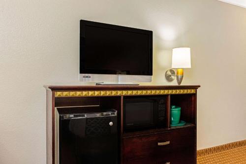 a flat screen tv sitting on top of a entertainment center at La Quinta by Wyndham Cleburne in Cleburne