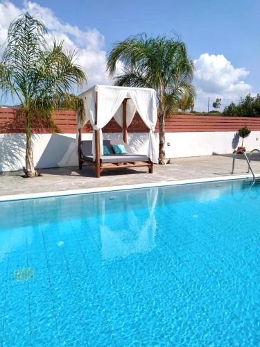 a chair sitting next to a swimming pool at Dorieus Villa in Lachania