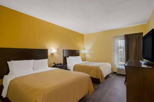 a hotel room with two beds and a flat screen tv at Quality Inn Jefferson at I-85 in Jefferson