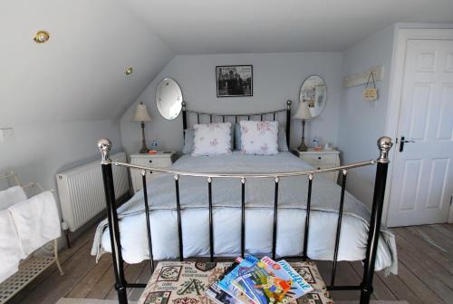 a bedroom with a bed and two mirrors on the wall at Westshore House- fabulous waterfront home Fife in Pittenweem
