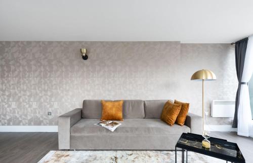a living room with a couch and a table at Oxford Street Fitzrovia Apartments by D'Montrio in London