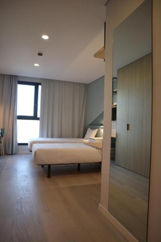 a bedroom with a bed and a large window at MEU STUDIO in Gandra