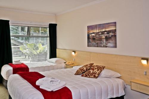 a hotel room with two beds and a window at Picton Accommodation Gateway Motel in Picton