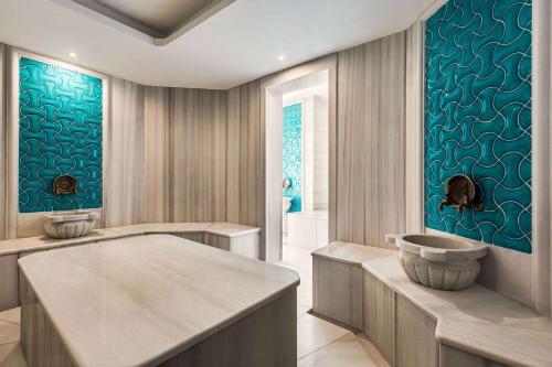 a bathroom with a bath tub and a sink at Ramada by Wyndham Karapinar in Karapınar