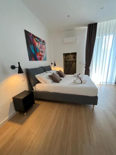 a bedroom with a large bed and a wooden floor at Summertime in Bisceglie