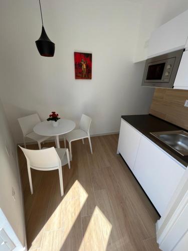 a small kitchen with a table and chairs in a room at Summertime in Bisceglie