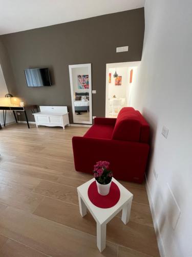 a living room with a red couch and a table at Summertime in Bisceglie
